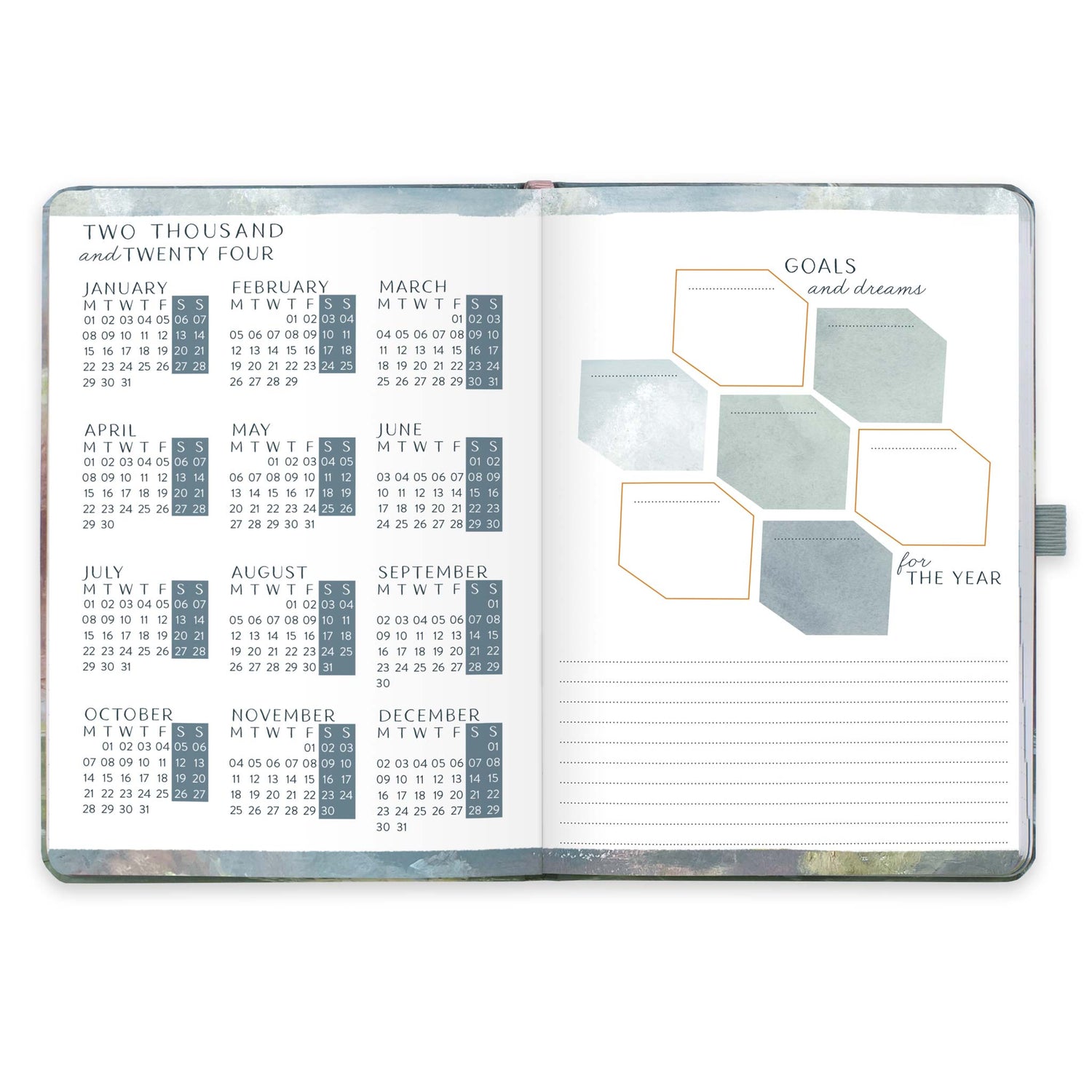 An open diary planner with a goals and dreams for the year page and a page with year microcalendars for 2024 and 2024