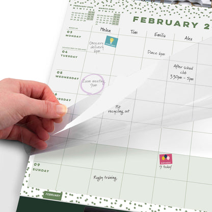A calendar page showing February 2025 and writing, with  a hand moving the transparent overlay