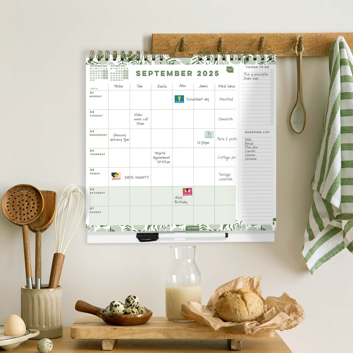 Family weekly planner calendar hung on a kitchen wall.