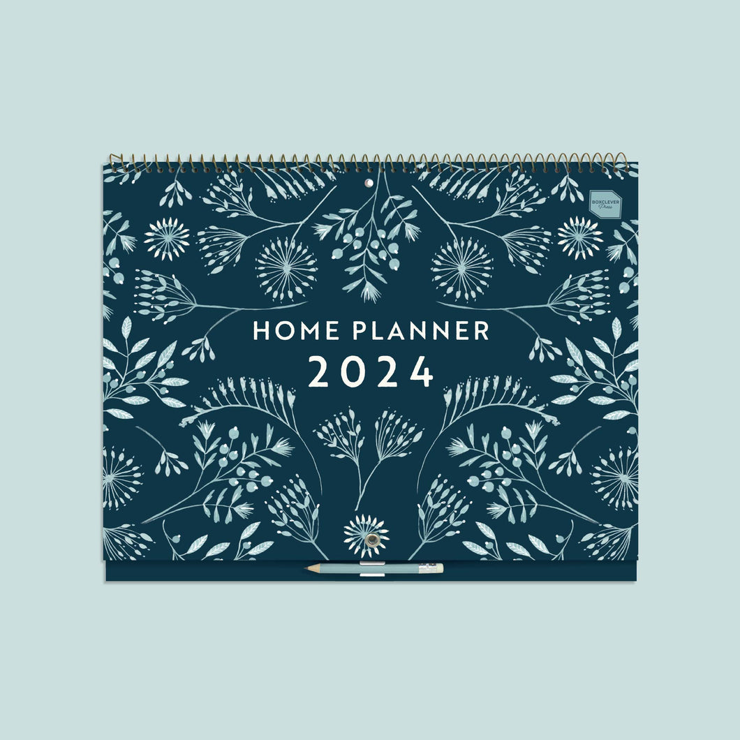 Home planner calendar 2023 2024 with a dark blue cover and floral pattern and a light blue clip on pencil