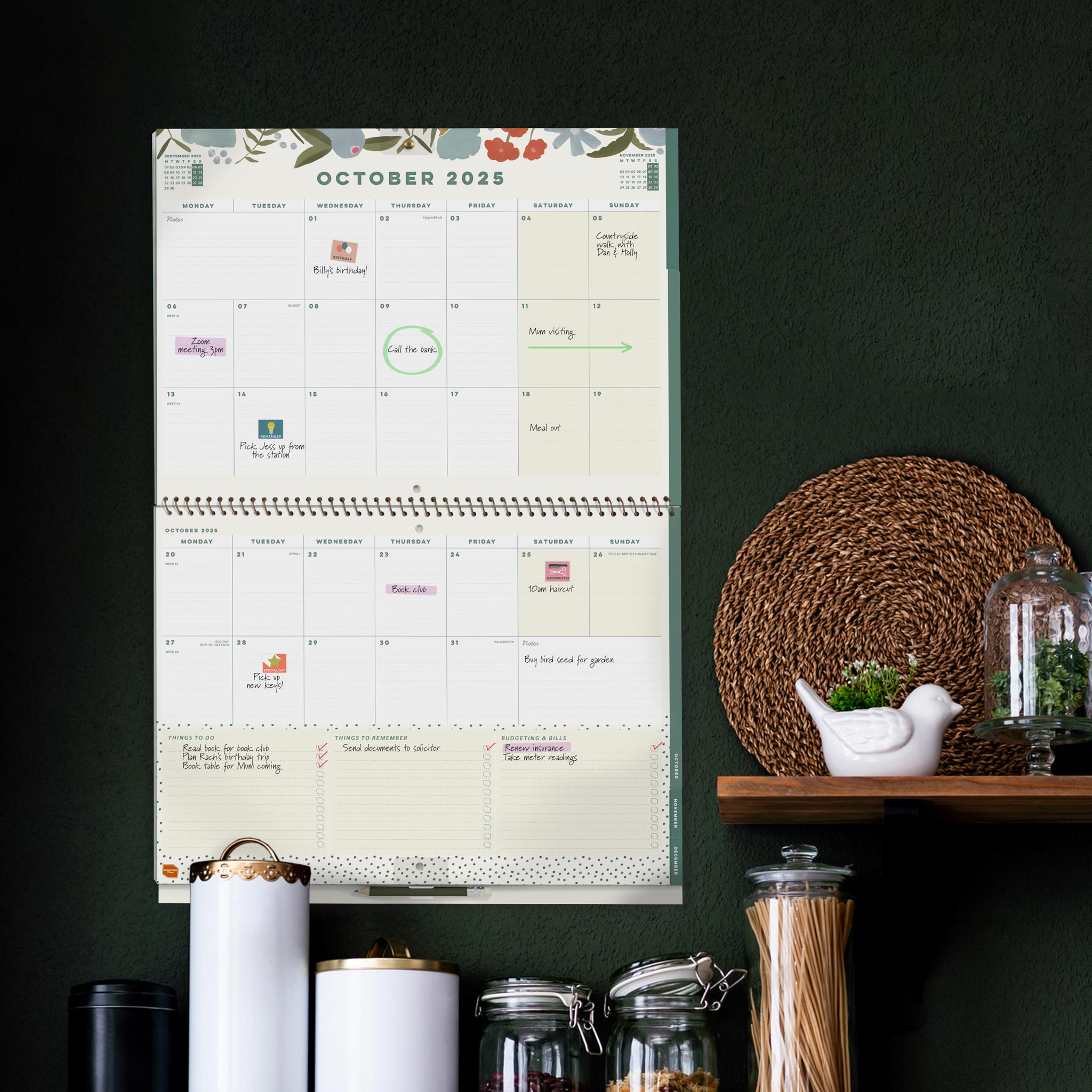Home planner calendar 2025 hung on a green kitchen wall.