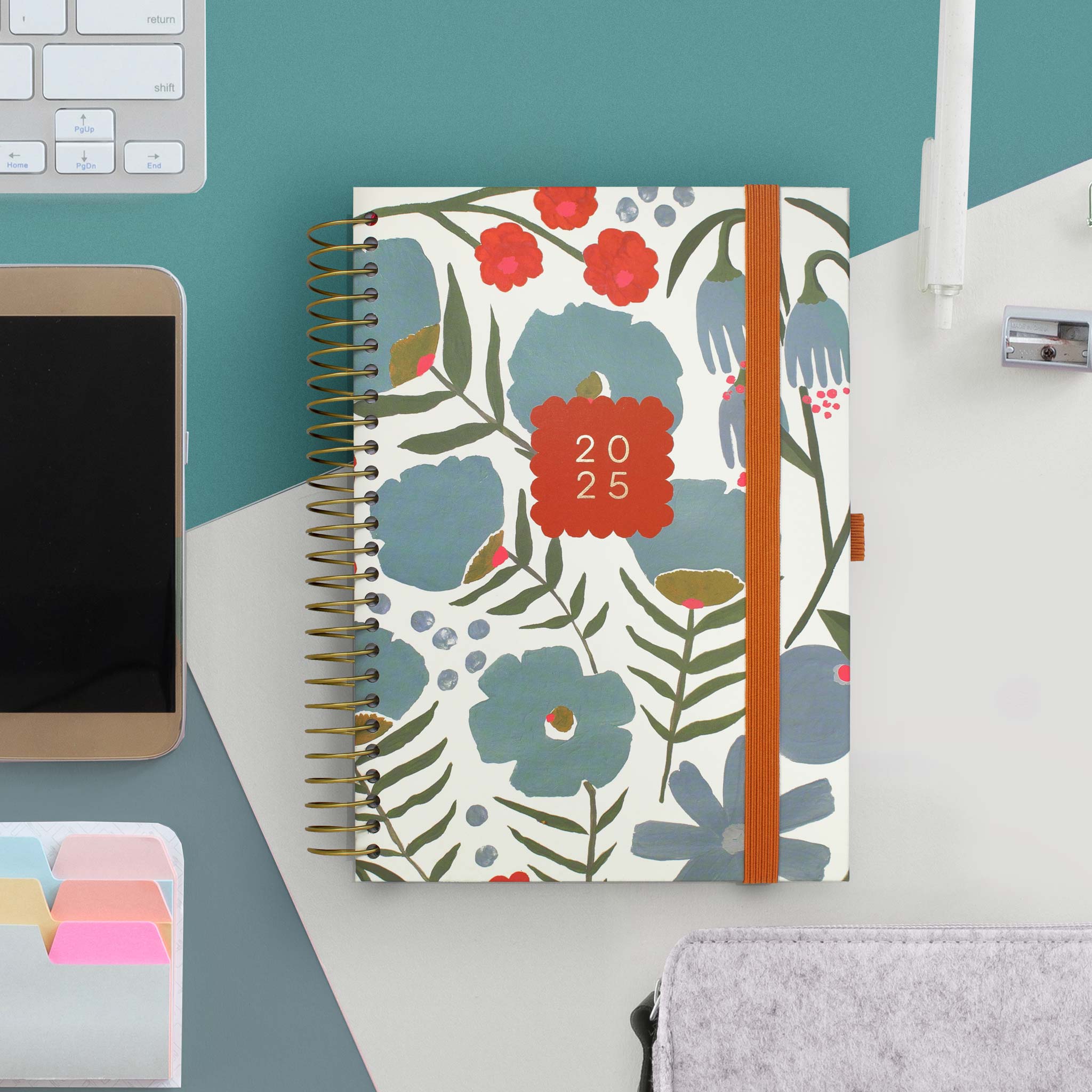 A spiral bound diary planner with floral design