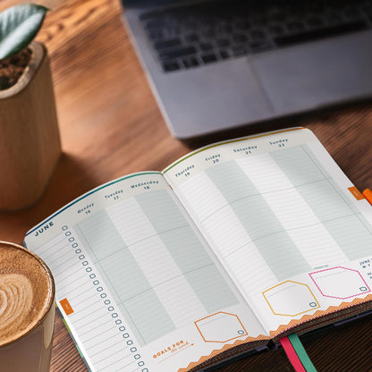 Open appointment diary with vertical layout on a wooden desk. 