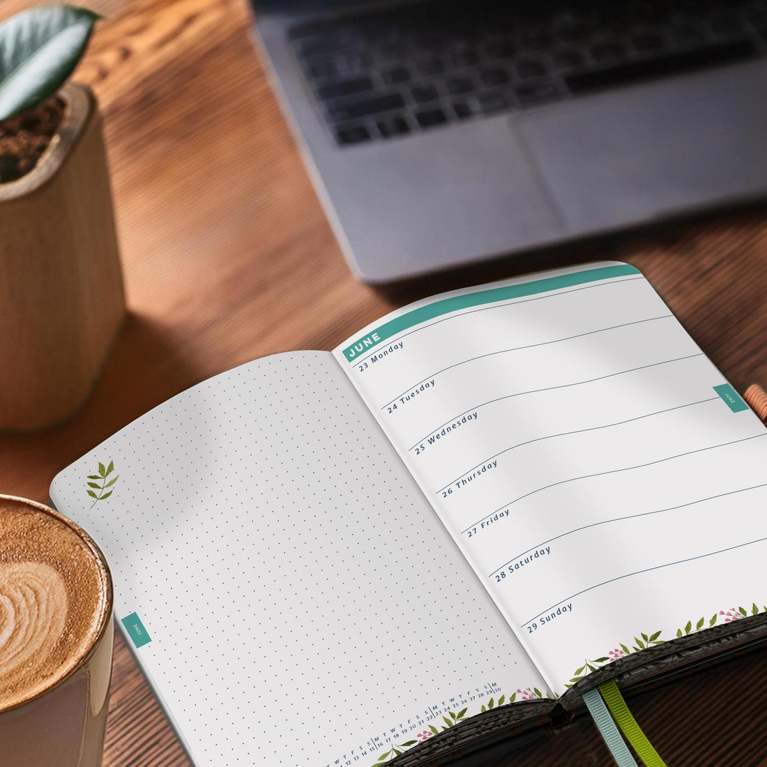 Open Everyday weekly diary on a desk next to a coffee and a plant in a stone pot. 


