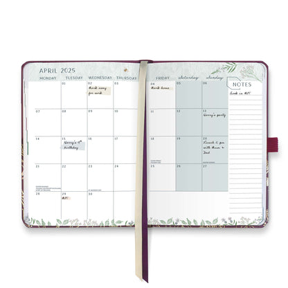 An open page diary spread with a month at a glance calendar, note space and ribbon page markers