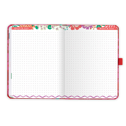 An open diary with dotted notes and lists pages.