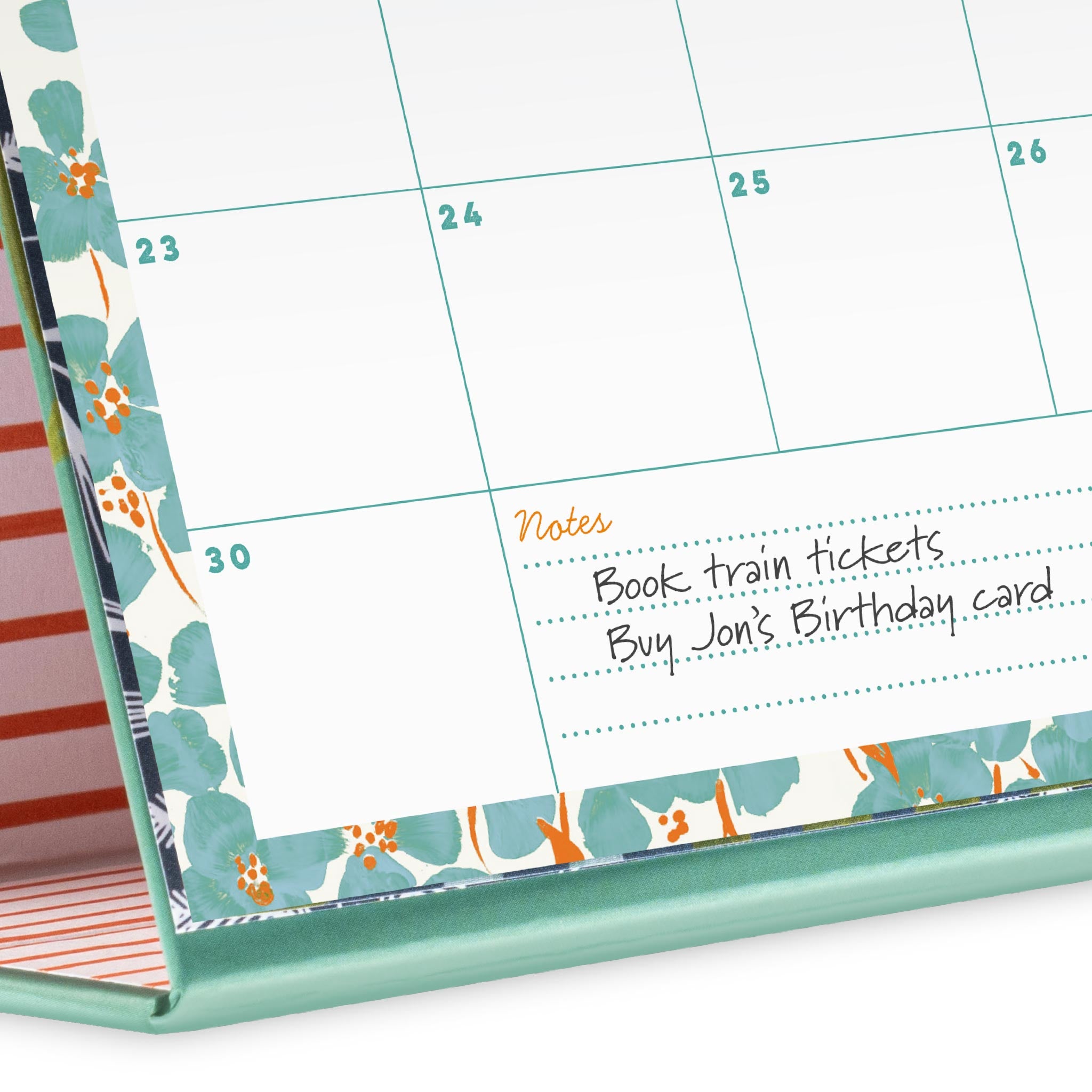 A close up of a calendar page showing the note space with a note to book train tickets and buy a birthday card.