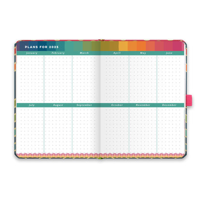 An open diary planner with plans for 2025 and dotted note space for each month. 
