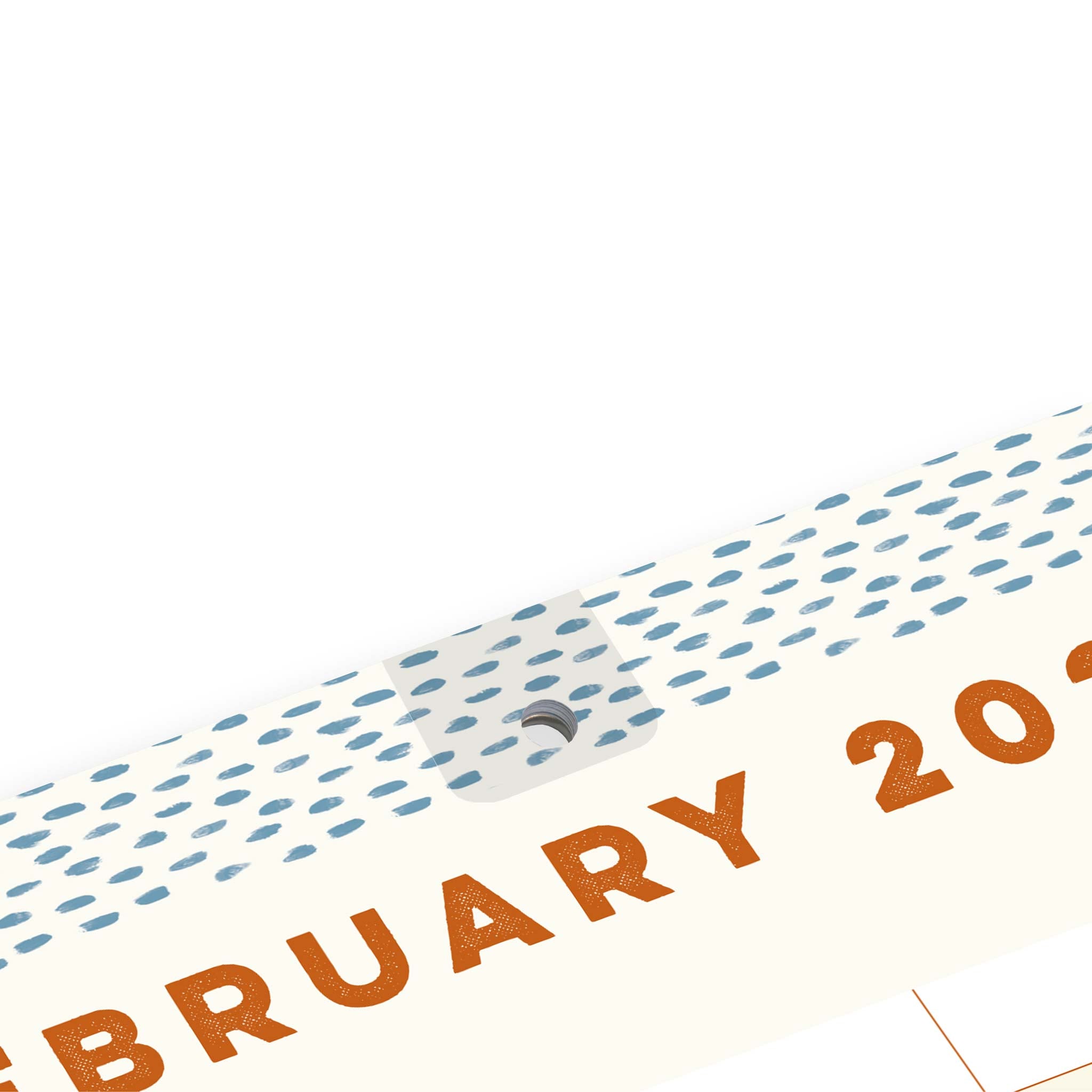 A February calendar page with blue dots and a reinforced hanging hole