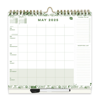 A wall calendar page with a 6 column weekly layout, lists and a clip on pen.