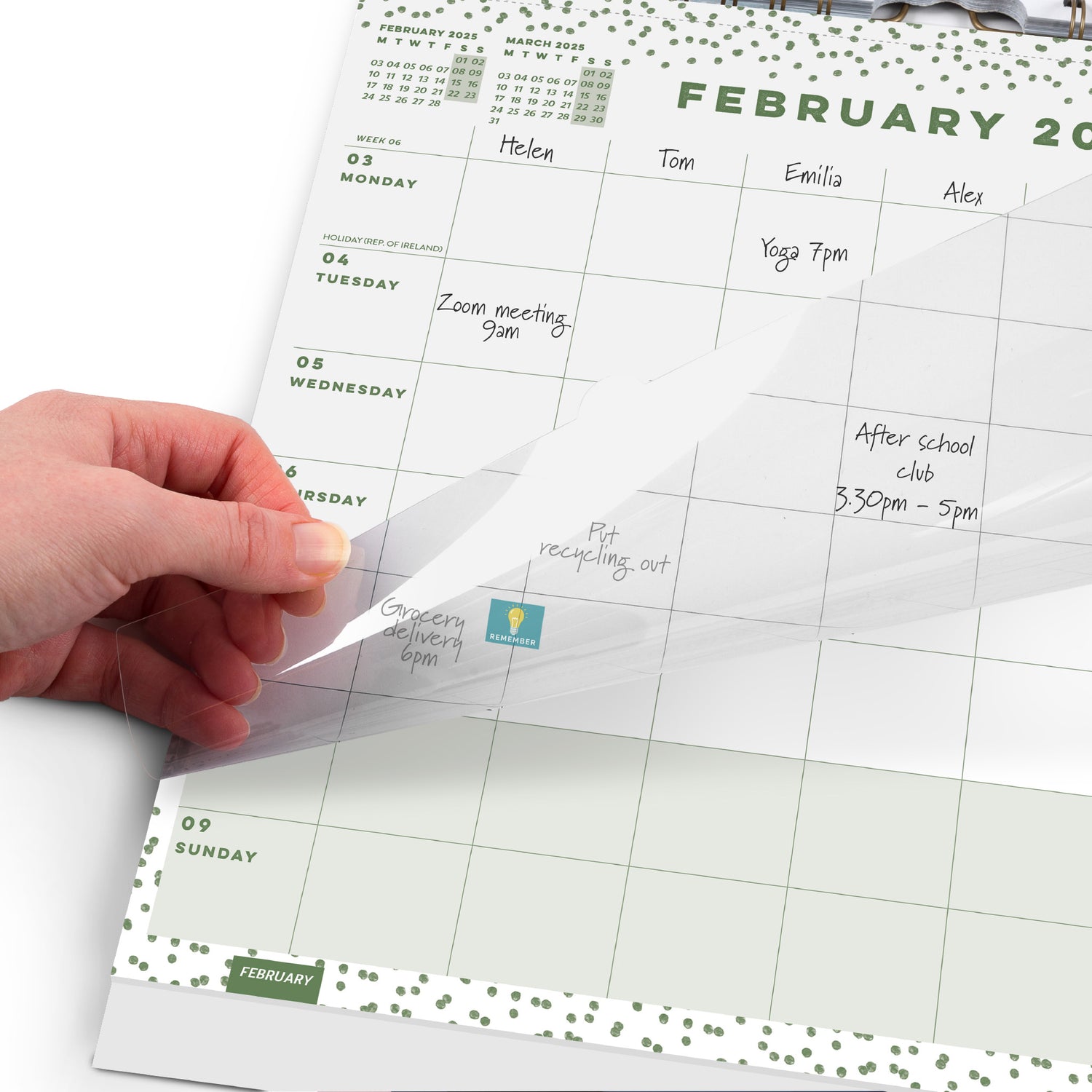 A calendar page showing February 2025 and a hand moving the transparent overlay.