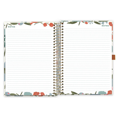 &quot;An open diary spread with floral pattern showing lined note pages &quot;