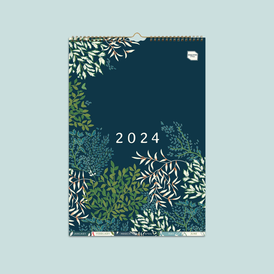 Boxclever Press Perfect Year A3 family calendar 2024 with a dark blue cover, green, white and blue leaf patterns and monthly tabs