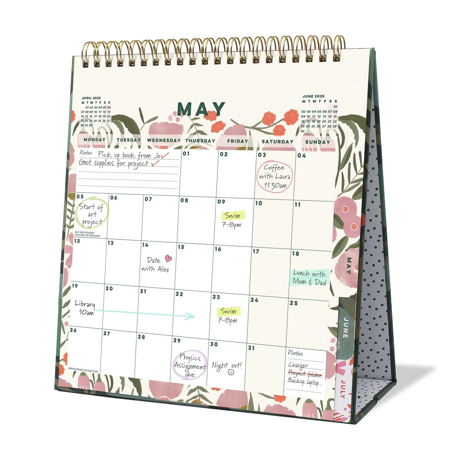 An open desk calendar page with floral pattern for May with appointments and notes